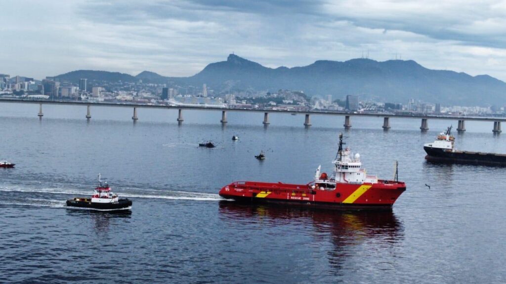 MCT offshore support vessel under way with a harbour tug